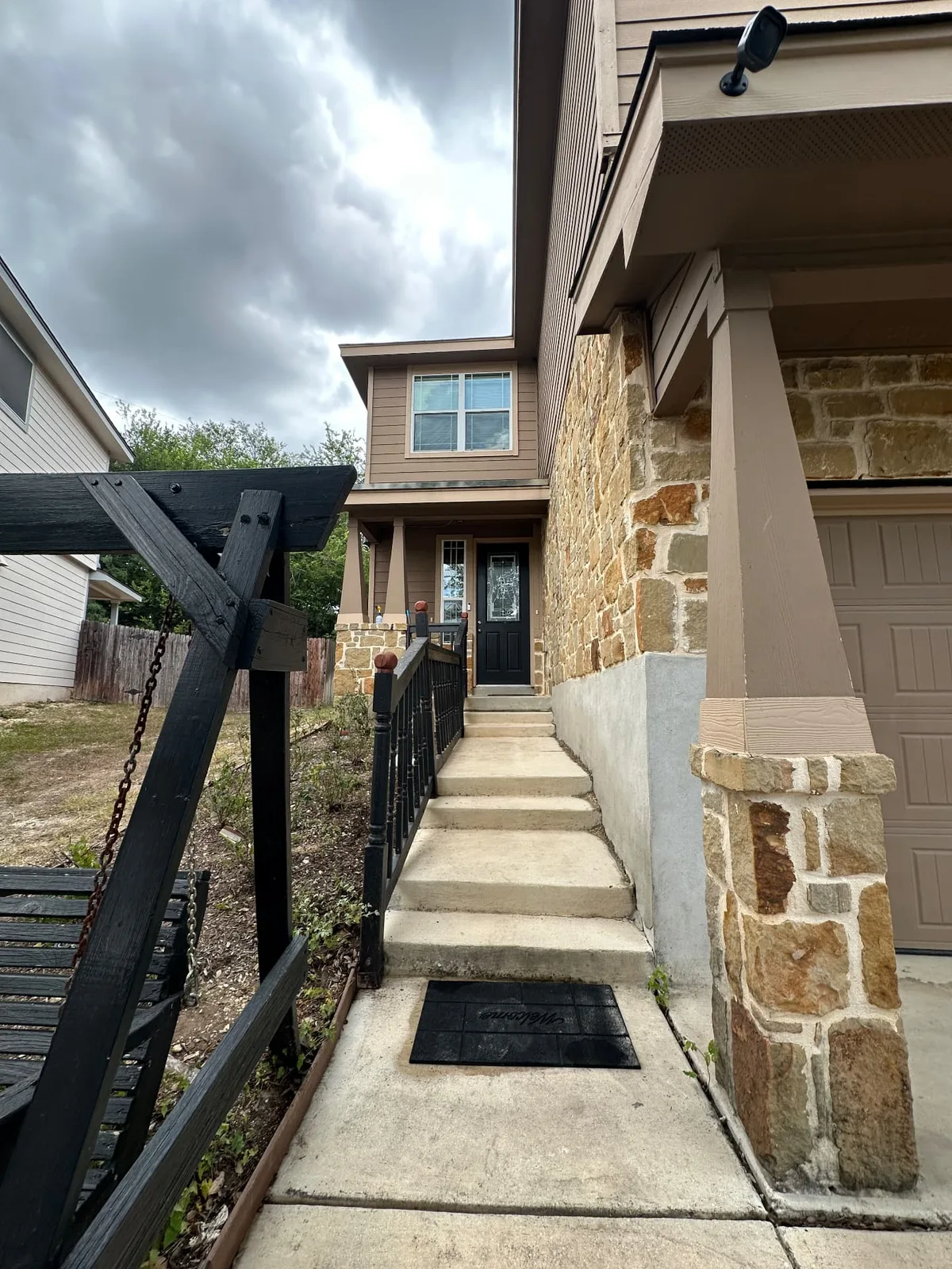 The same front entry steps and walkway after pressure washing, with clean, brightened concrete.